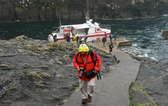 George climbing up from ferry at Mykines