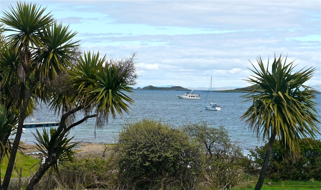 Venture II at anchor in Small Isles Bay with palms