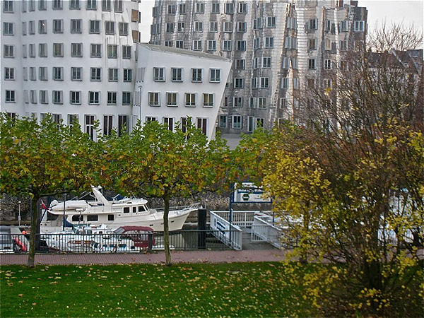 Venture II in marina near funky buildings